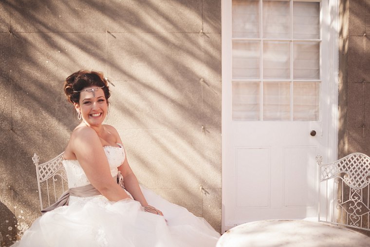 A photograph of a bride sat in shade at Swarling Manor near Canterbury in Kent