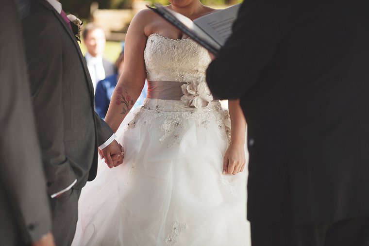 Bride and Groom holding hands during the ceremony of their wedding at Swarling Manor in Kent