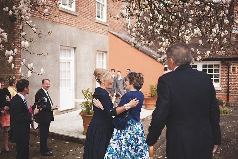 The mothers of the bride and groom hugging at their childrens wedding at Swarling Manor in Kent