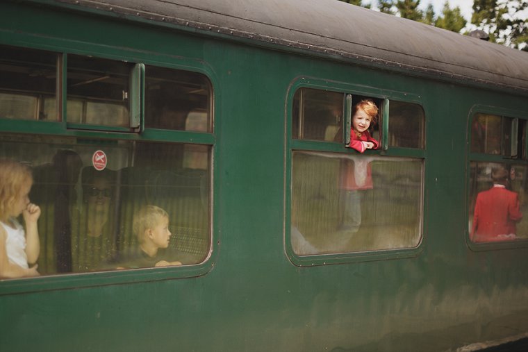 A young red headed wedding guest at High Rocks in Kent