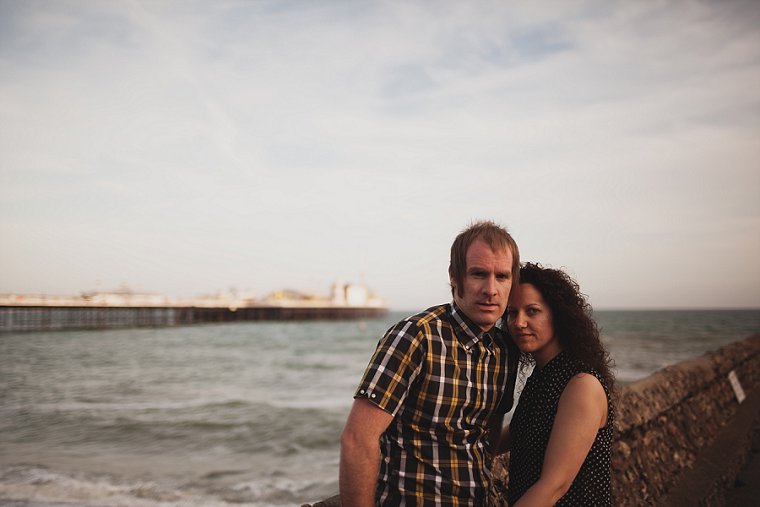 Engagement photo of couple on Brighton Beach with Brighton pier in the backgrounf