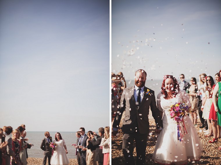 Wedding couple having confetti thrown at them on Whitstable beach in Kent