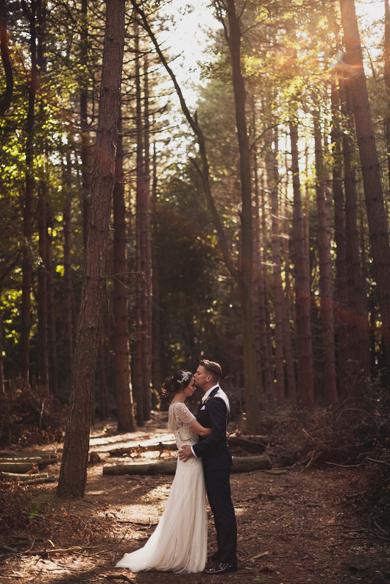 Groom tenderley kissing the forehead of his bride