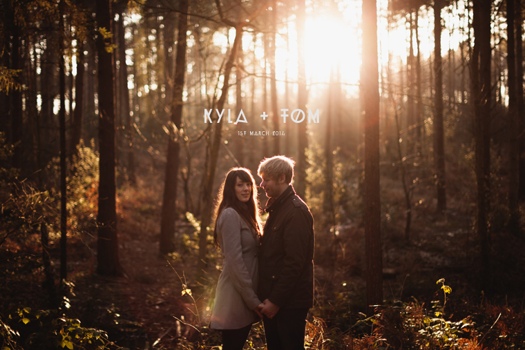 Kyla and Tom Pre Wedding Shoot at Bedgebury Forest in Kent 001 Kyla and Tom stood together on their pre wedding shoot in a sunlit forest at dusk. Photograph is taken at Bedgebury Pinetum and Forest in Tunbridge Wells in Kent