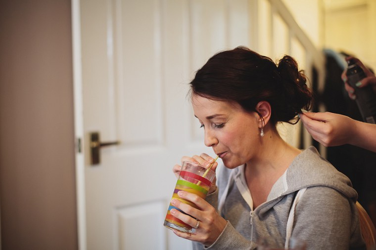 Bride laughing and sipping a drink