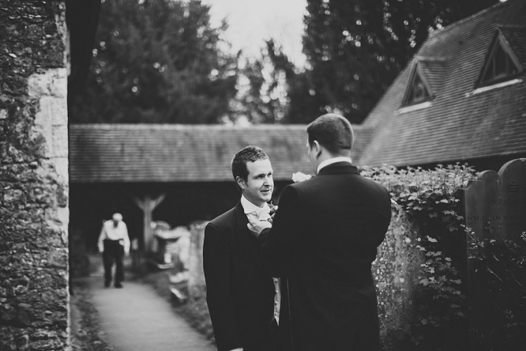 Best Man adjusting the tie of the groom before the wedding ceremony
