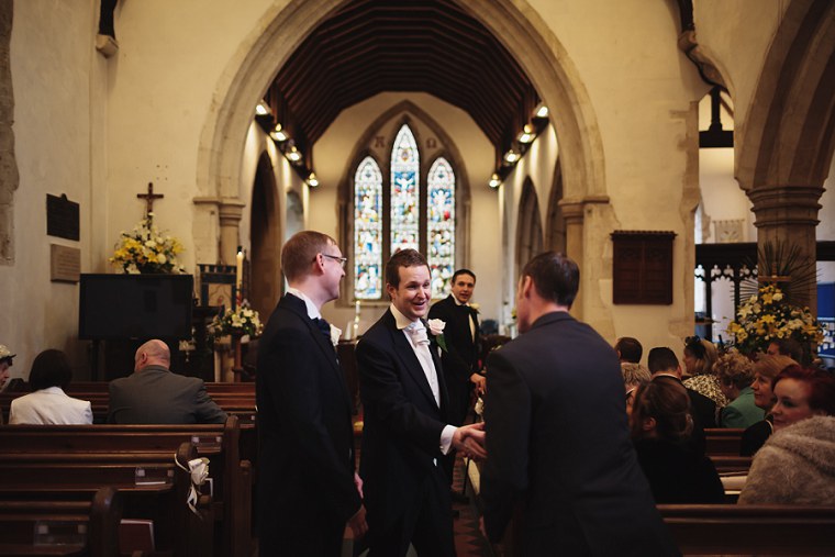 Groom shaking hands with a wedding guest