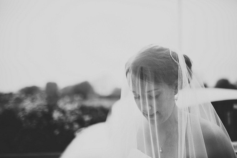 Black and white wedding photography of bride through her veil