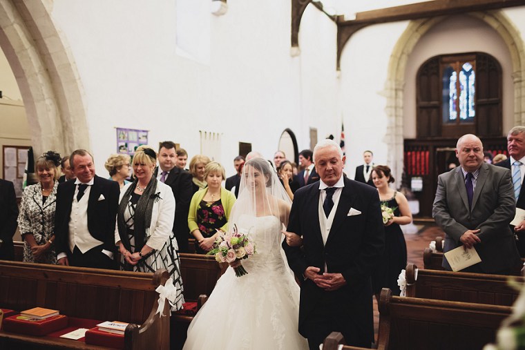 Bride walking down the aisle with the father of the bride