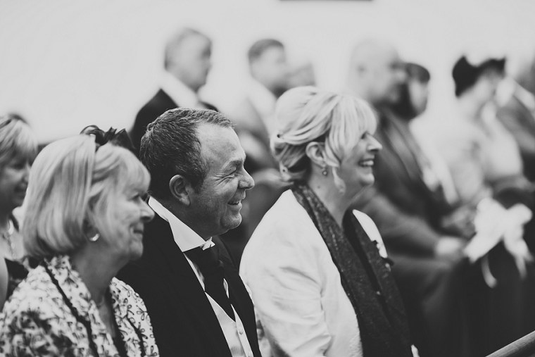 Father of the groom laughing during the wedding ceremony
