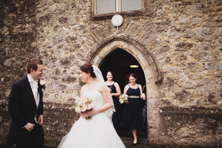 Bridesmaids exiting St Mary's church in Kent