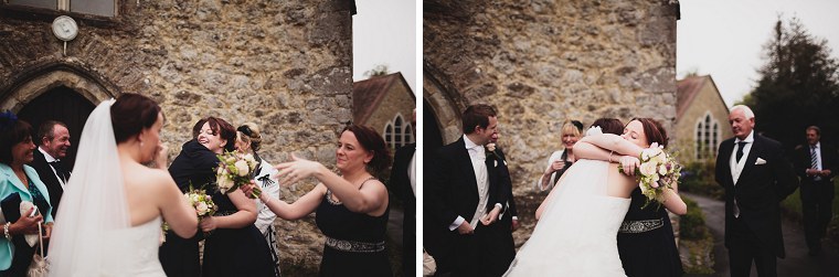 Bridemaids hugging the bride