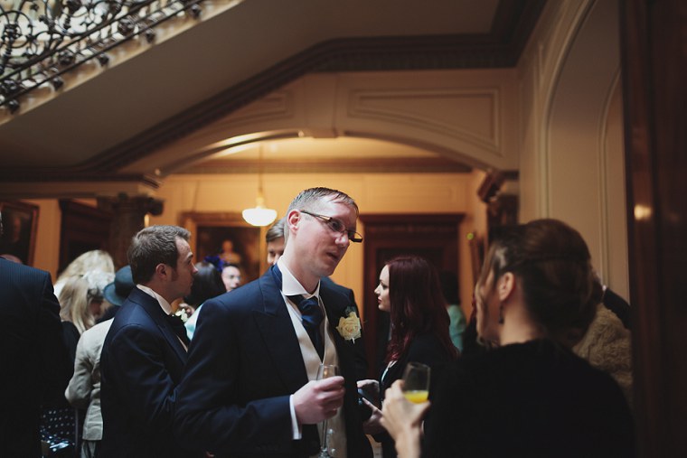 Groomsmen chatting to wedding guest at Mount Ephraim in Kent