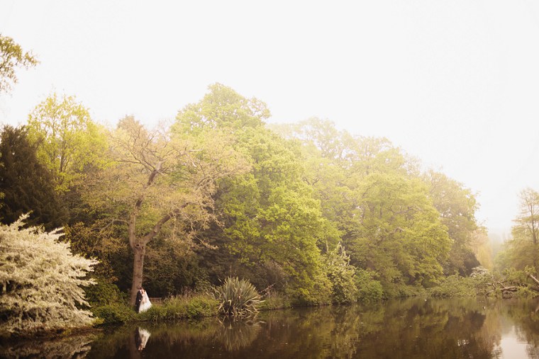 Wedding portrait of bride and groom next to the lake at Mount Ephraim Gardens