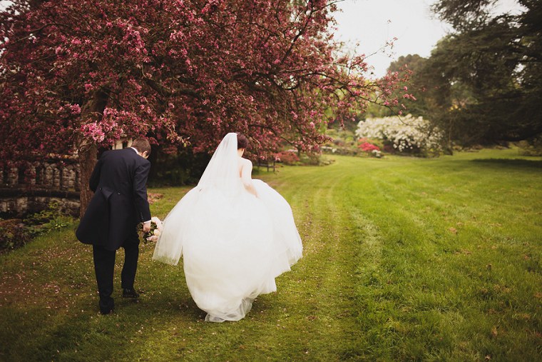 Bride and Groom walking through the gardens of Mount Ephraim in Kent