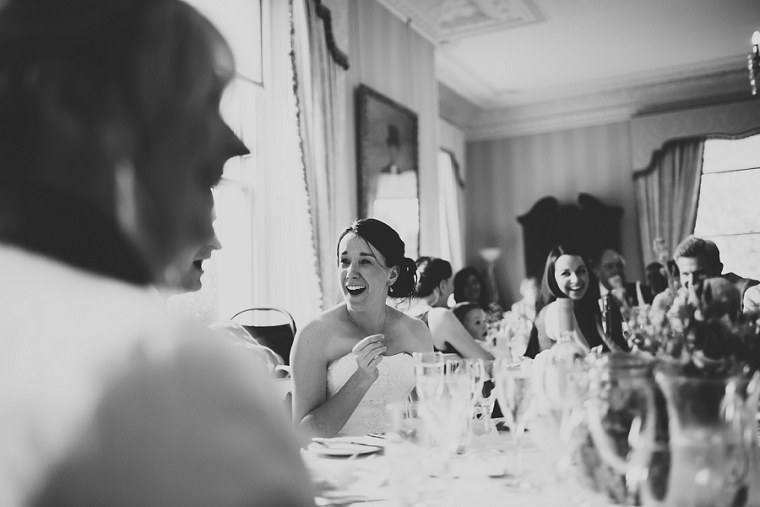 Bride looking happy during wedding speeches