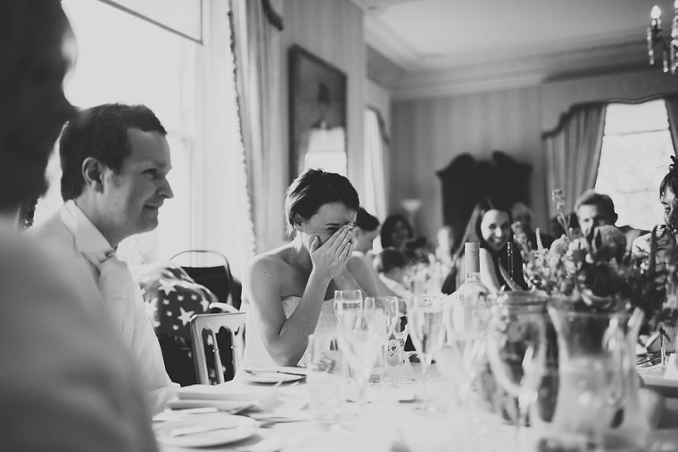 Bride laughing during her fathers wedding speech