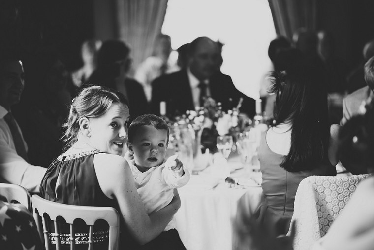 Bridesmaid holding her son at Mount Ephraim Gardens