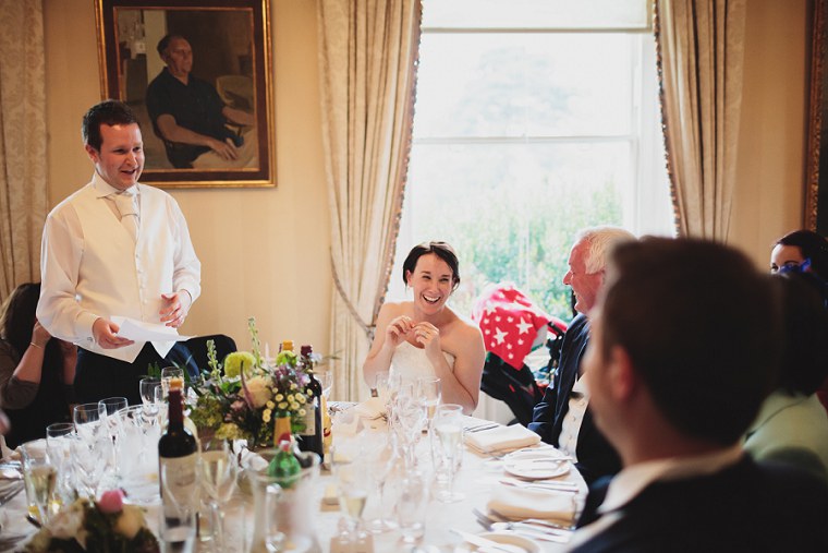 Bride laughing at wedding speeches