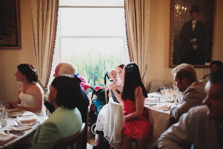 Young page boy watchig wedding speeches at Mount Ephraim Gardens in Kent