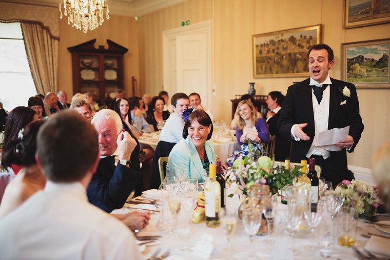 Mother of the bride laughing during the best mans speech
