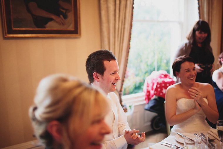 groom laughing during the best mans wedding speech
