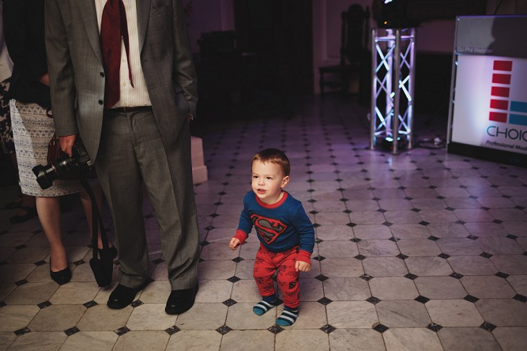 Young boy dancing during wedding reception