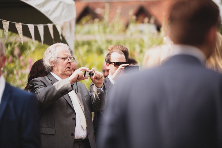 Wedding guest taking photo of bride at Falconhurst Estate