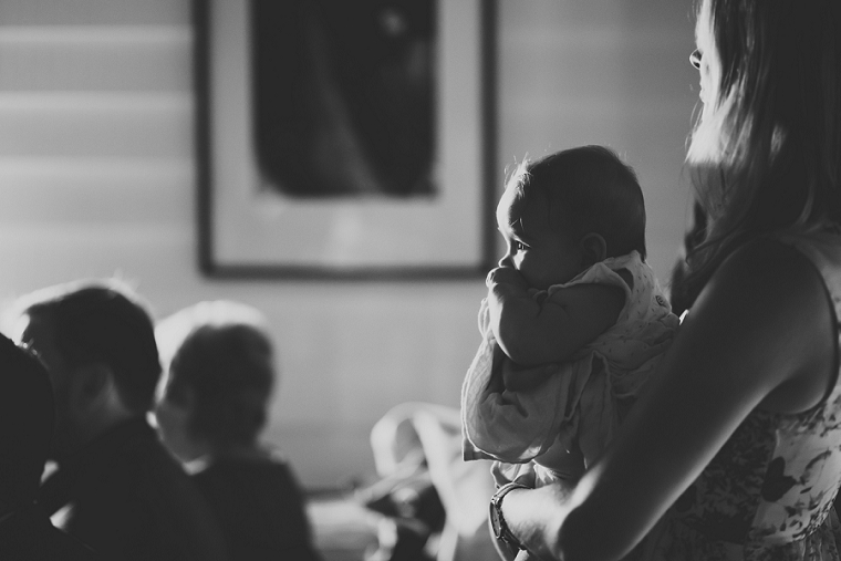 Baby looks on during wedding ceremony at East Quay Lobster Shack in Whitstable