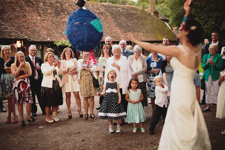 Wedding pinata candid photography of guests